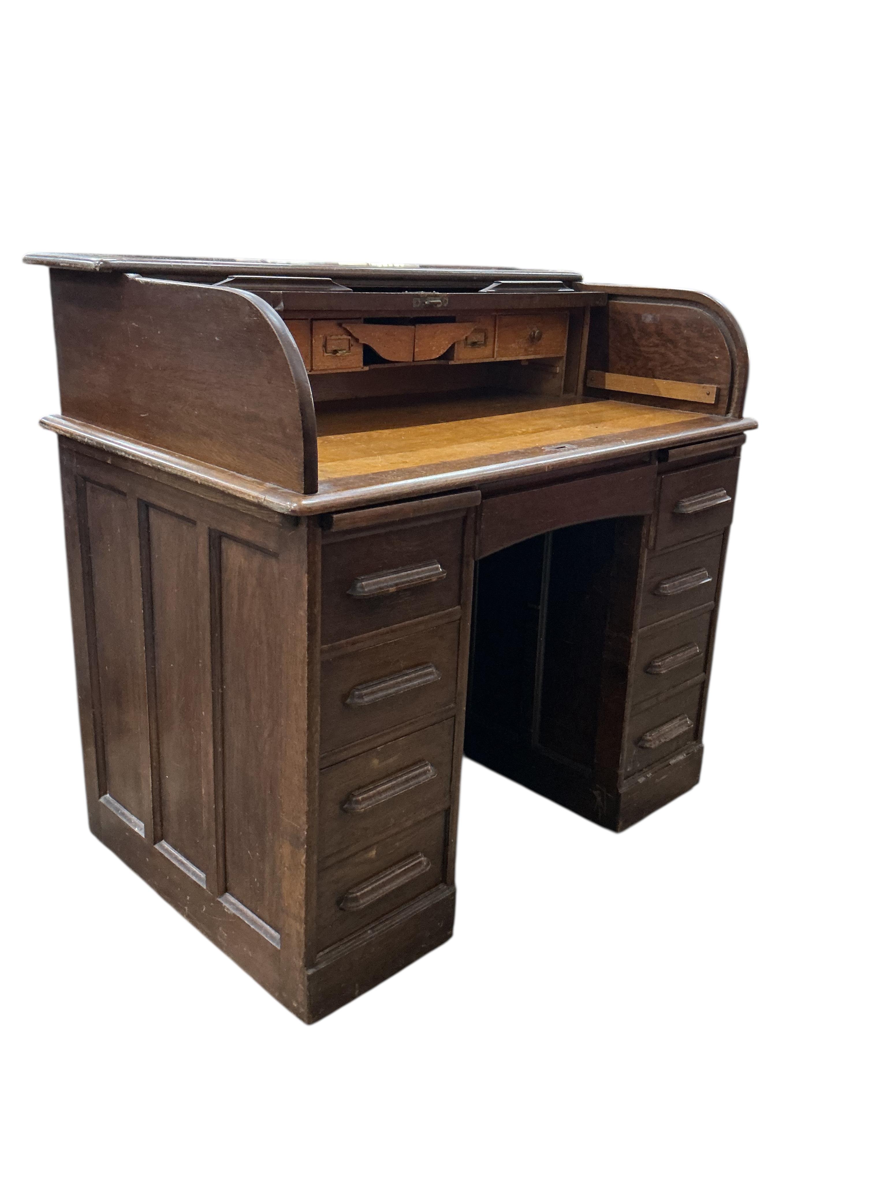 An early 20th century American oak roll top desk, width 106cm, depth 68cm, height 101cm